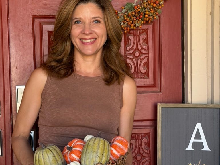 Woman holding fake pumpkins