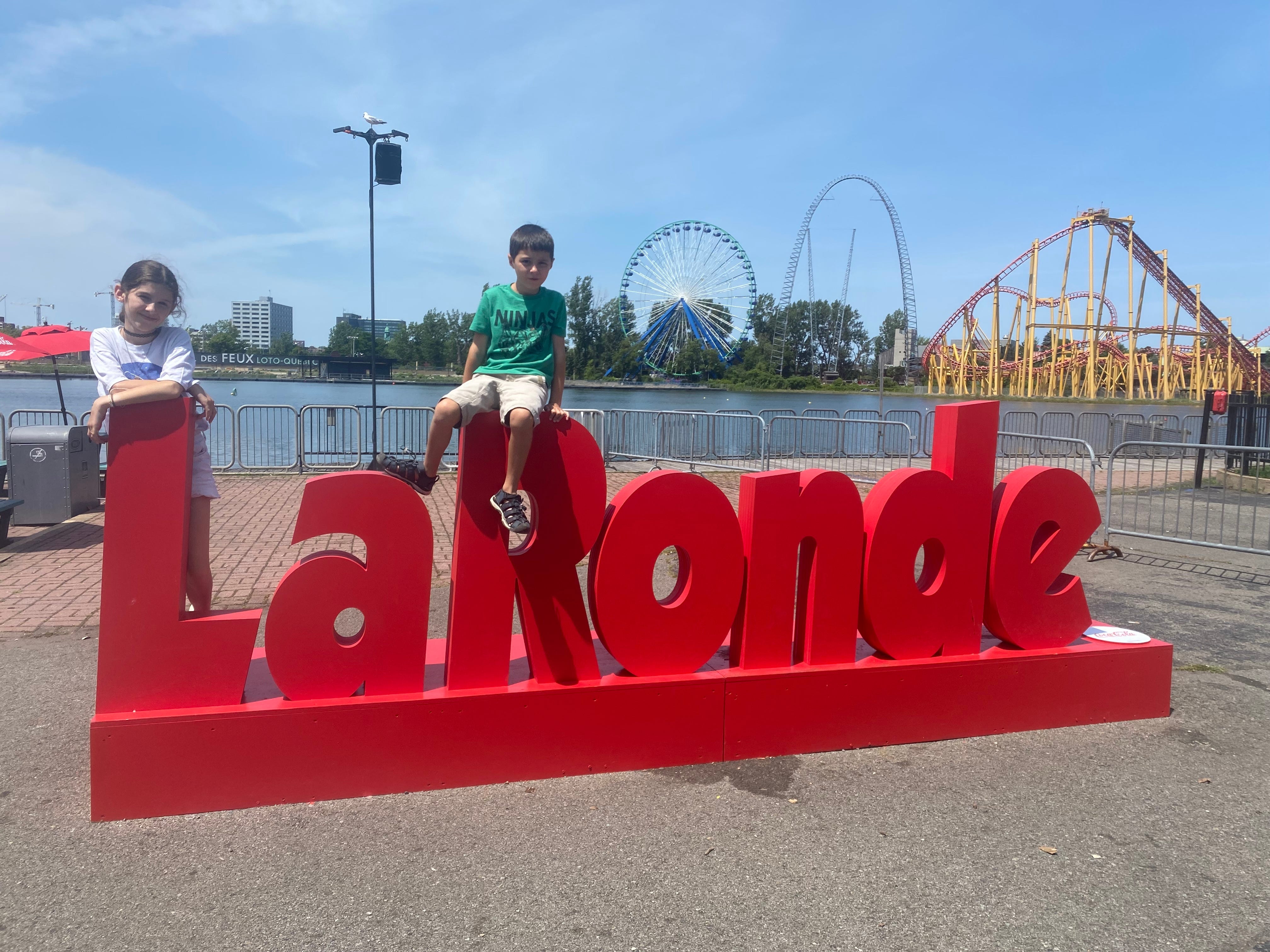 The authors children pose on a sign at La Ronde aumsement park in Quebec.