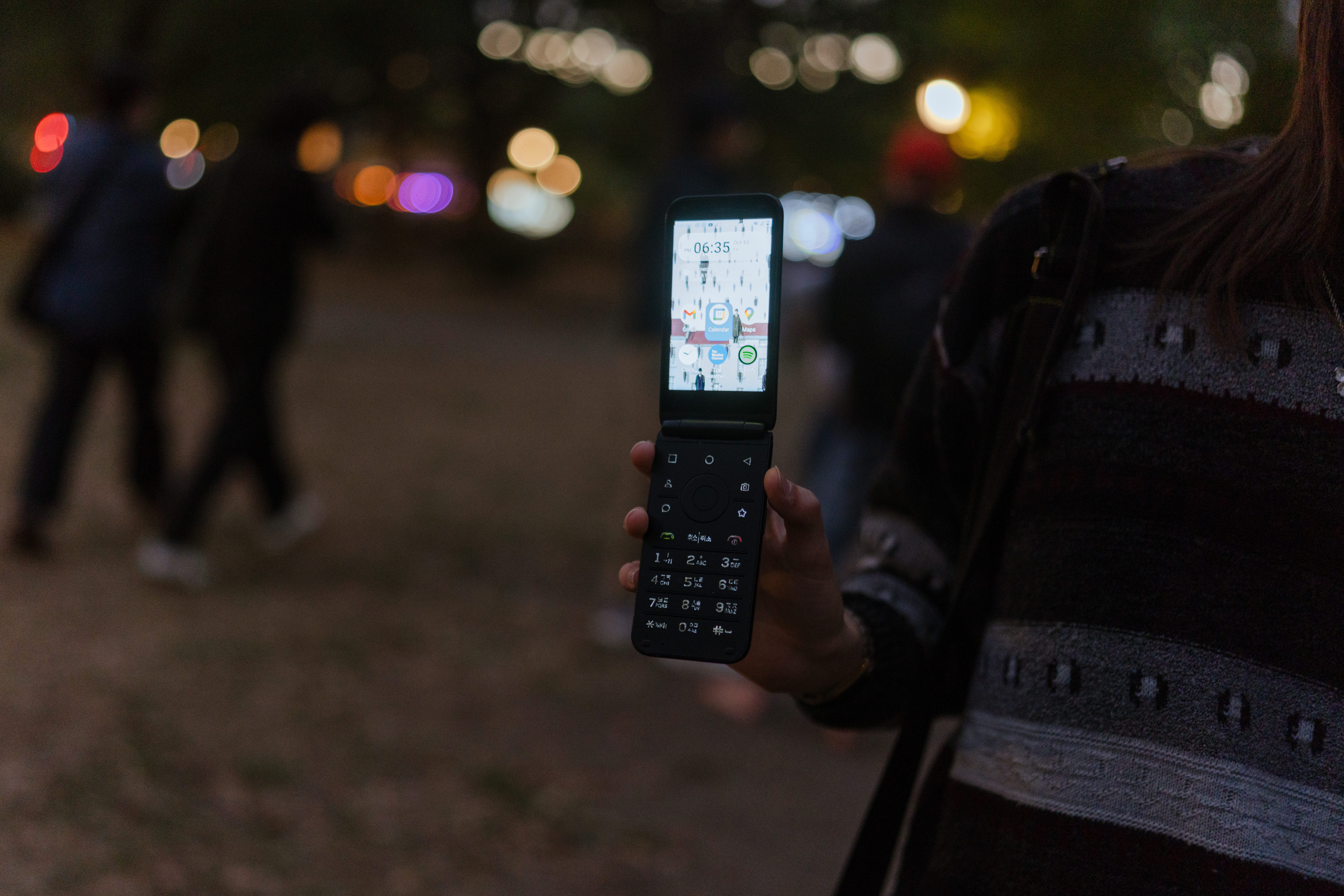 A person holding a flip phone