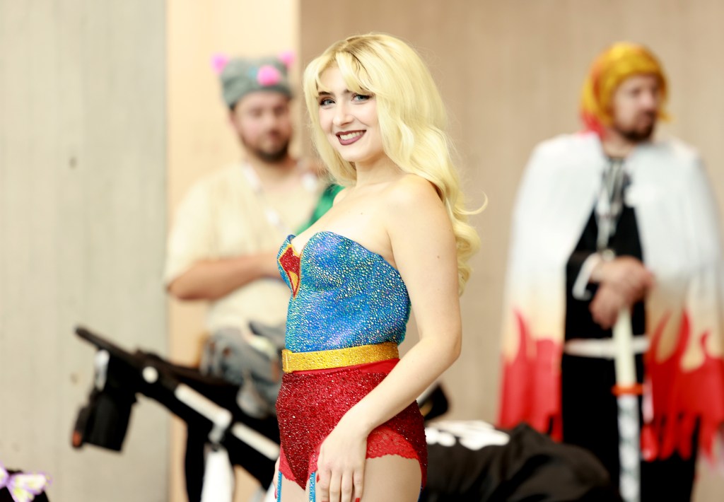 A cosplayer posed in a SuperMan skirt at New York Comic Con 2025