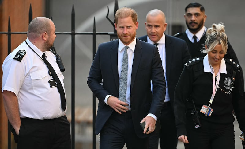 Prince Harry, Duke of Sussex, walks with security as he arrives at the Royal Courts of Justice, Britain's High Court, in central London, on April 8, 2025. Prince Harry will push ahead with a court challenge in London on Tuesday as the self-exiled royal fights a decision to downgrade his personal security when he visits Britain. Following Harry's dramatic split with the royal family in 2020 and subsequent move to North America, the British government said he would no longer be given the 