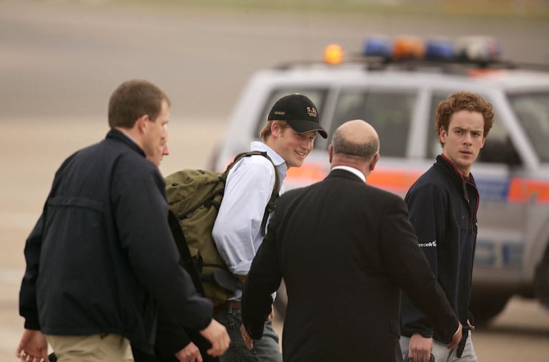 Britain's Prince Harry (2nd L) disembarks from an aircraft carrying the England rugby squad as they return to London's Heathrow airport, 22 October 2007. England lost 6-15 to South Africa in the 2007 Rugby World Cup final in Paris. AFP PHOTO/SHAUN CURRY (Photo by SHAUN CURRY / AFP) (Photo by SHAUN CURRY/AFP via Getty Images)