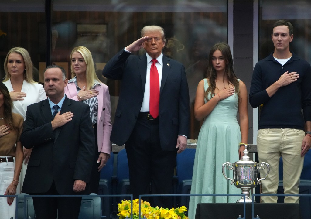Donald Trump saluting during the National Anthem with Karoline Leavitt, Dan Scavino, Pam Bondi, Arabella Kushner, and Jared Kushner at the U.S. Open finals.