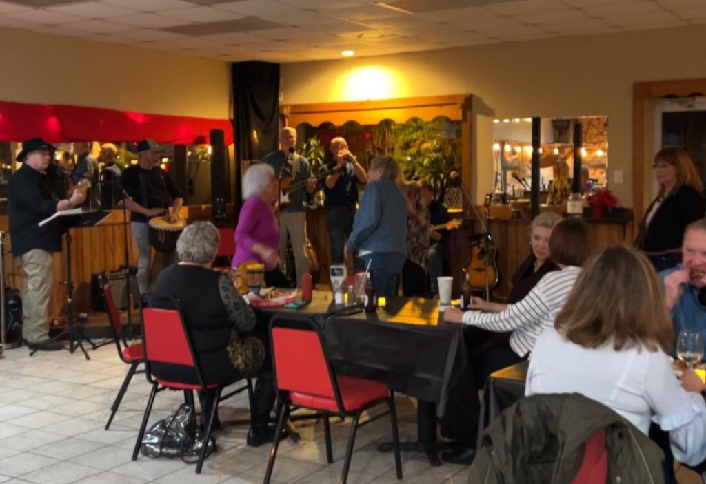 Willie's Bar and Grill in St. Helena, South Carolina, with a band performing and patrons socializing.
