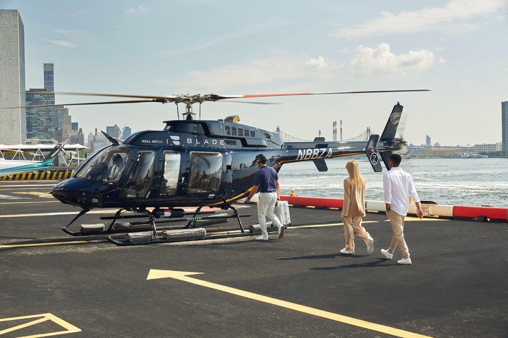 People walking into a Blade helicopter.
