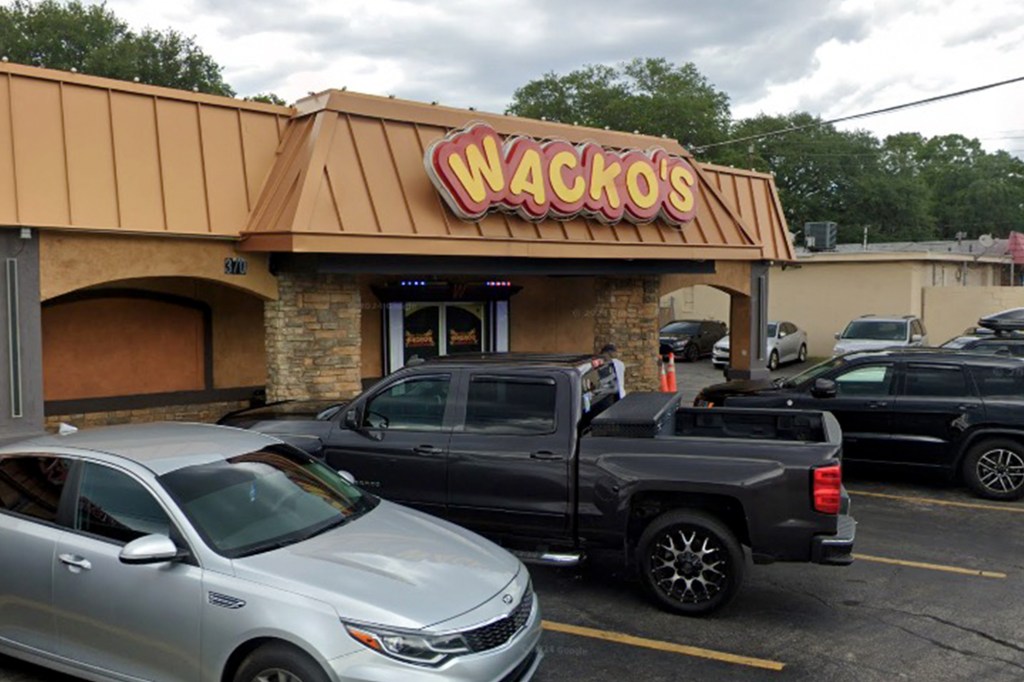 Exterior of Wacko's Gentlemen's Club in Jacksonville, FL, with cars parked in front.