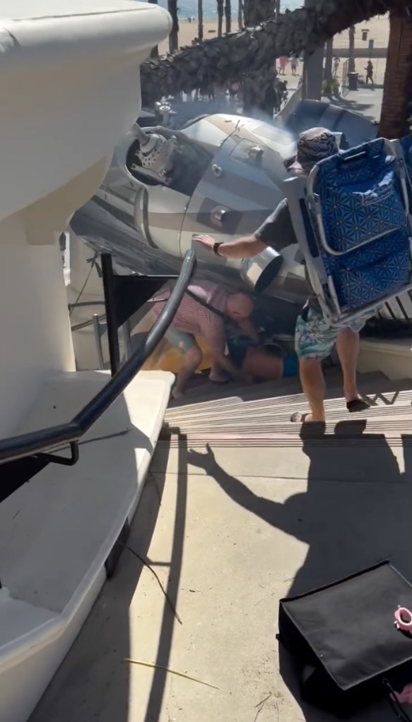 Bystanders rushing to help a child trapped under a Bell 22SP chopper after it crashed near a beach hotel.
