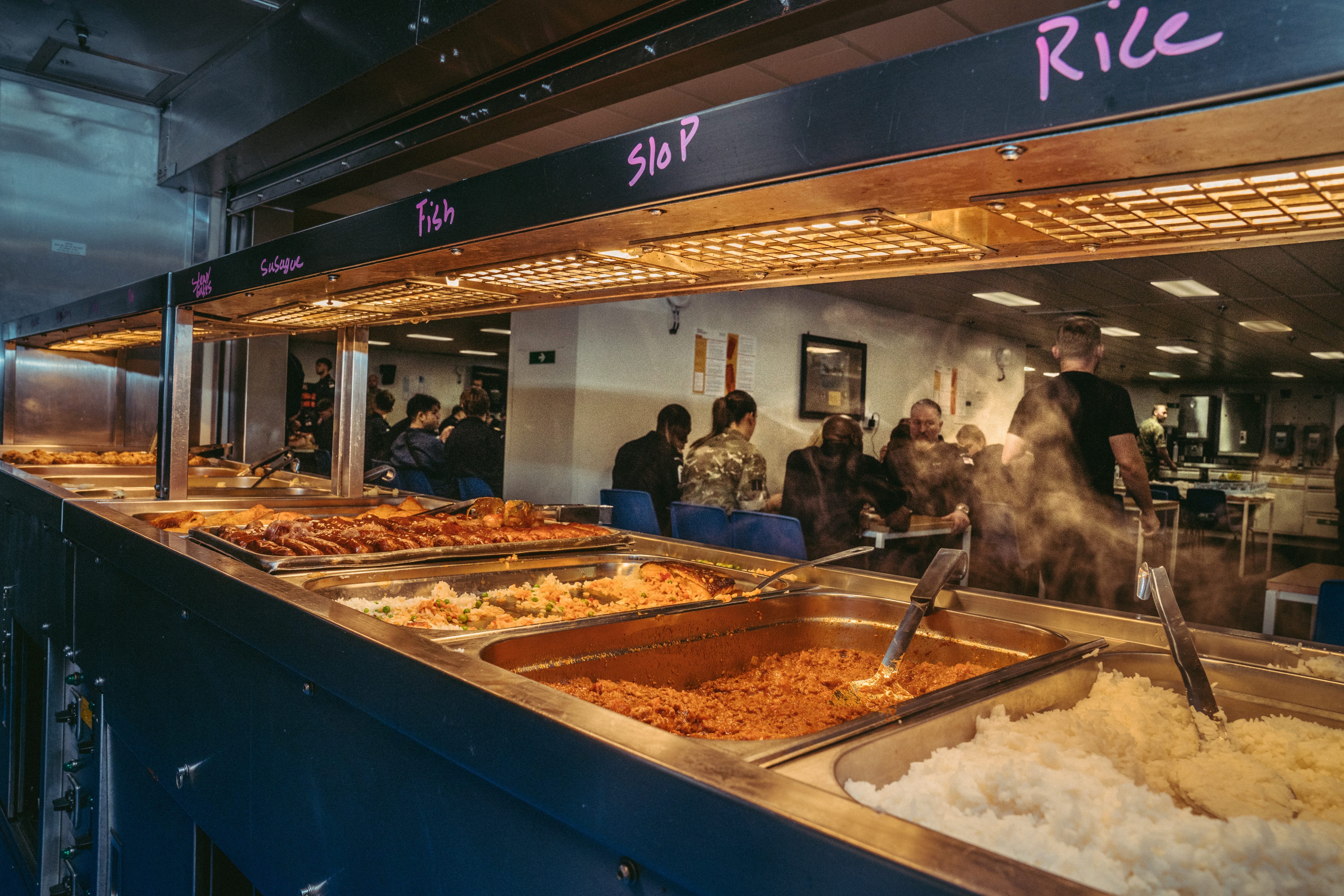 Royal Navy Sailor gathering their lunch at the junior rates dining area. Lunch is self service as other food services.