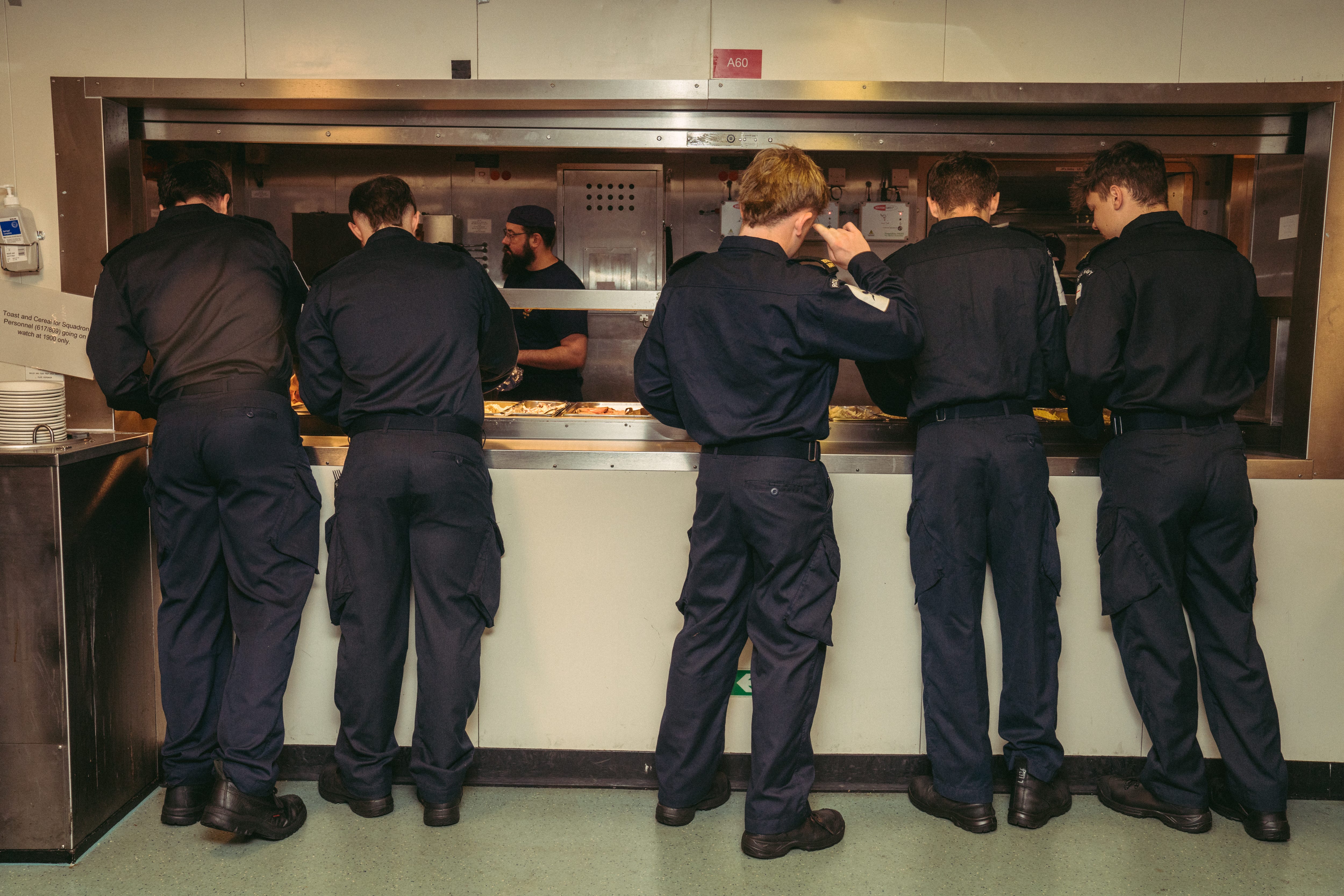 Royal Navy Sailor gathering their lunch at the junior rates dining area.