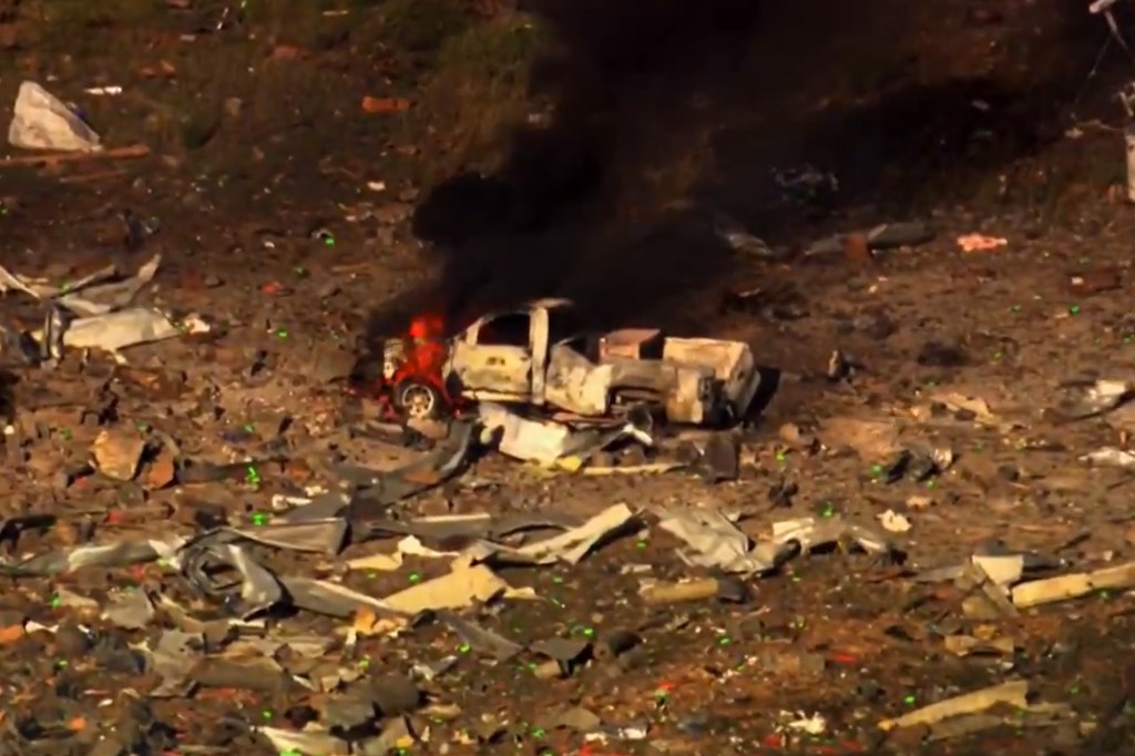 A pickup truck burns in the aftermath of an explosion at a Tennessee explosives manufacturer.