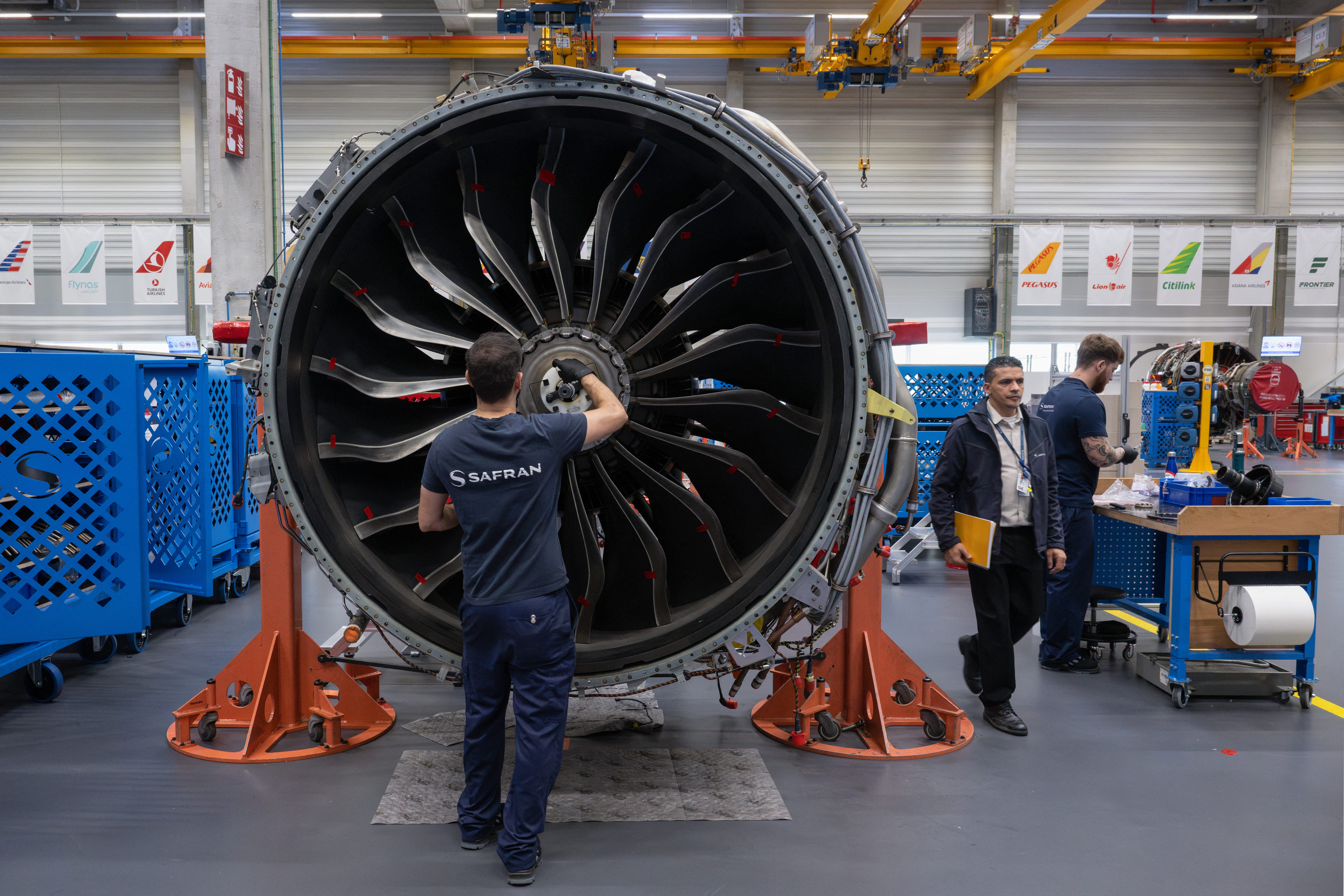 A Safran technicial works on a LEAP engine.
