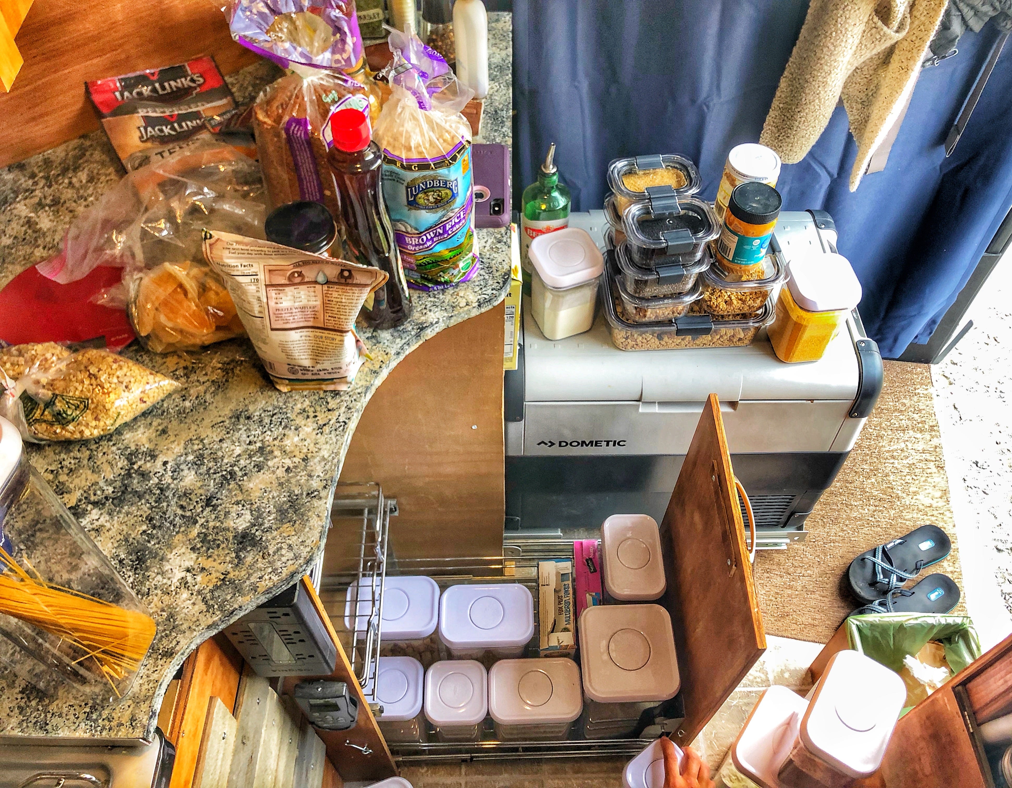 Interior of a van fillde with pantry items, storage containers