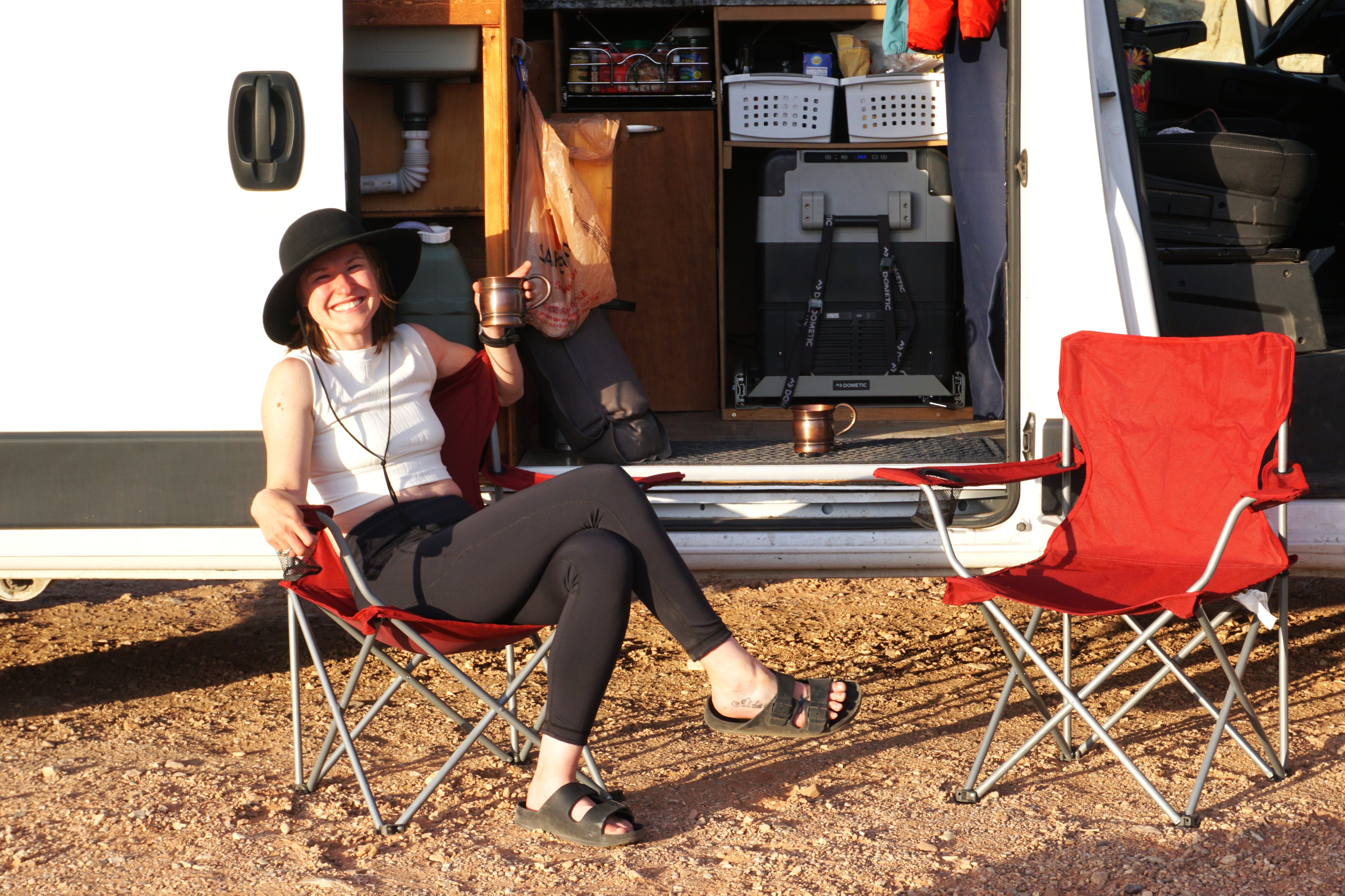 Author Amber McDaniel sitting in chair outside of van
