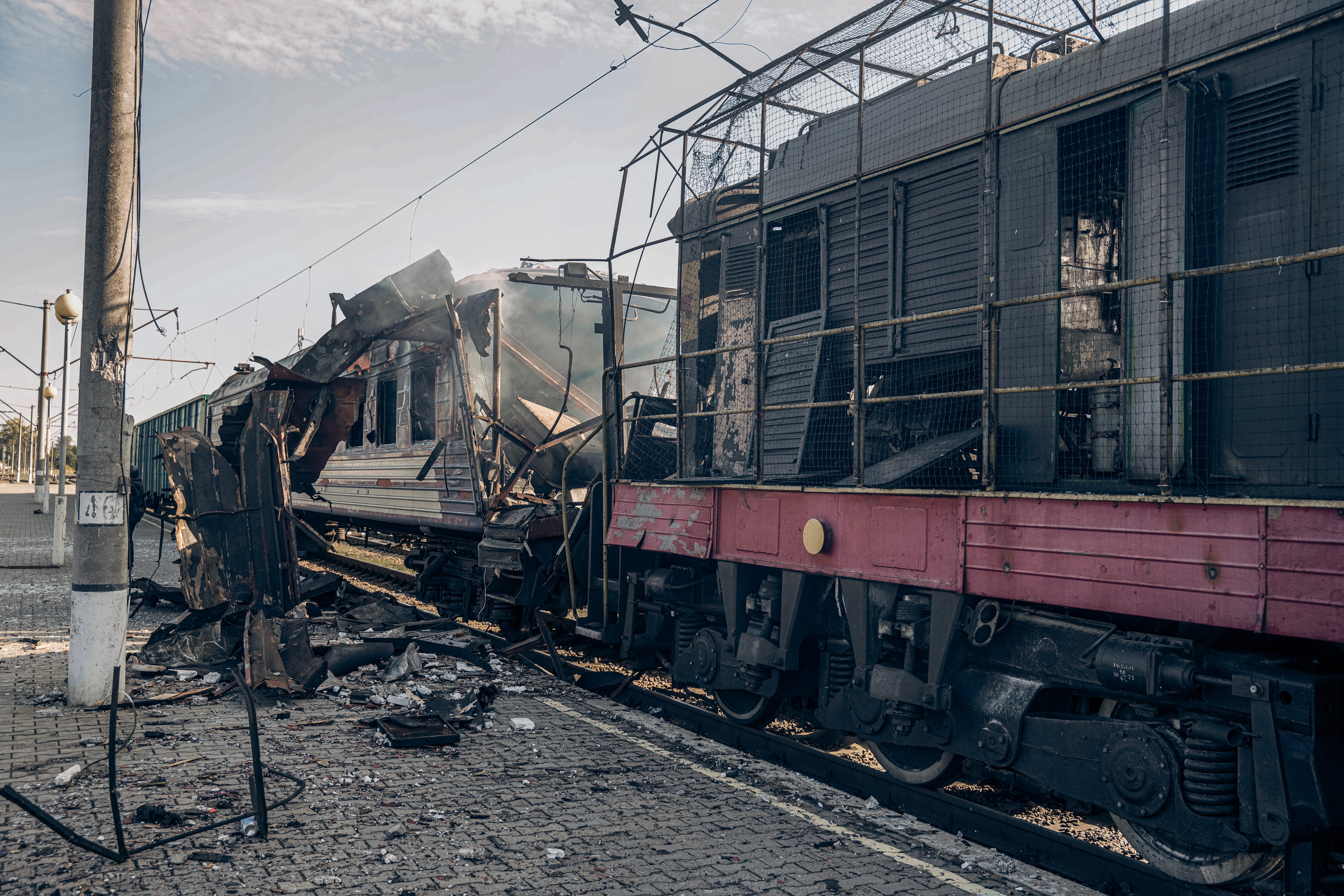 A 'Shostka-Kyiv' passenger train car, hit by a Russian drone, lies destroyed and burned on October 4, 2025 in Shostka, Sumy Oblast, Ukraine.