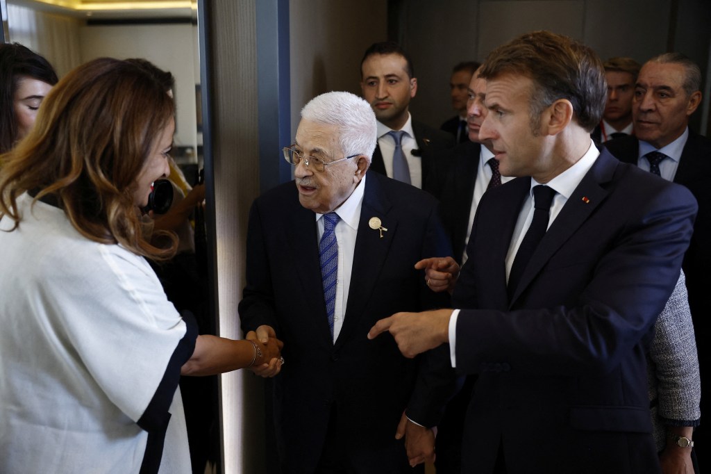 French President Emmanuel Macron and Palestinian President Mahmoud Abbas with French Parliament member Amal Lakrafi at the Gaza Peace Summit.
