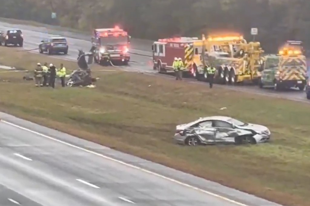 Wreckage of a small plane on I-95 in Massachusetts, with emergency vehicles and personnel around.