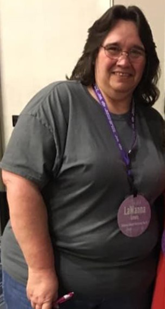 LaWanna Lewis wearing a grey shirt and purple lanyard.
