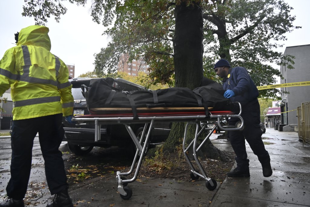 Medical examiners transporting a body bag on a stretcher from 207 Troy Avenue in Crown Heights, Brooklyn.