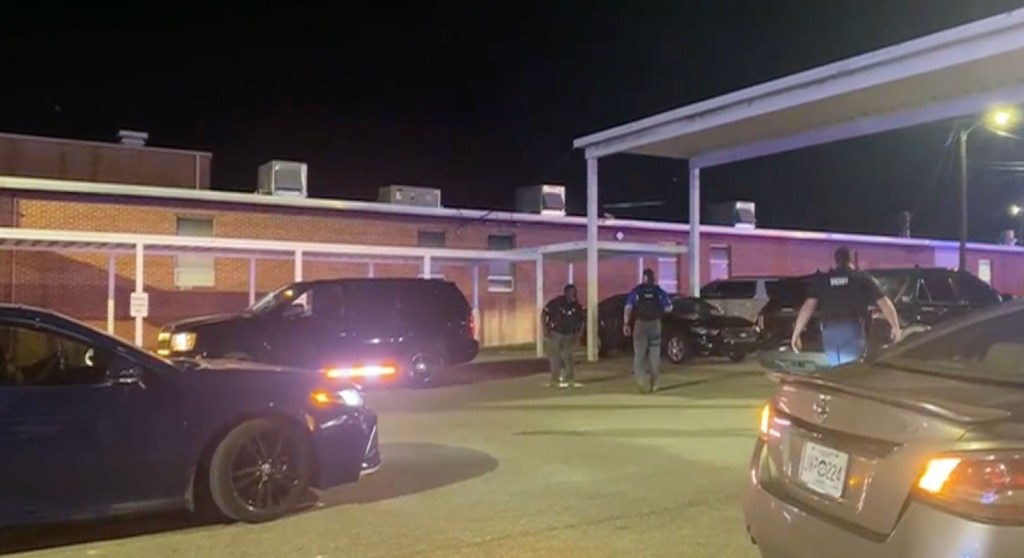 Police officers at a high school after a shooting.