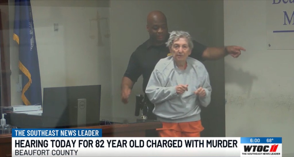 Harriet Kay Recker, 82, being escorted by a guard for her court hearing for murder.