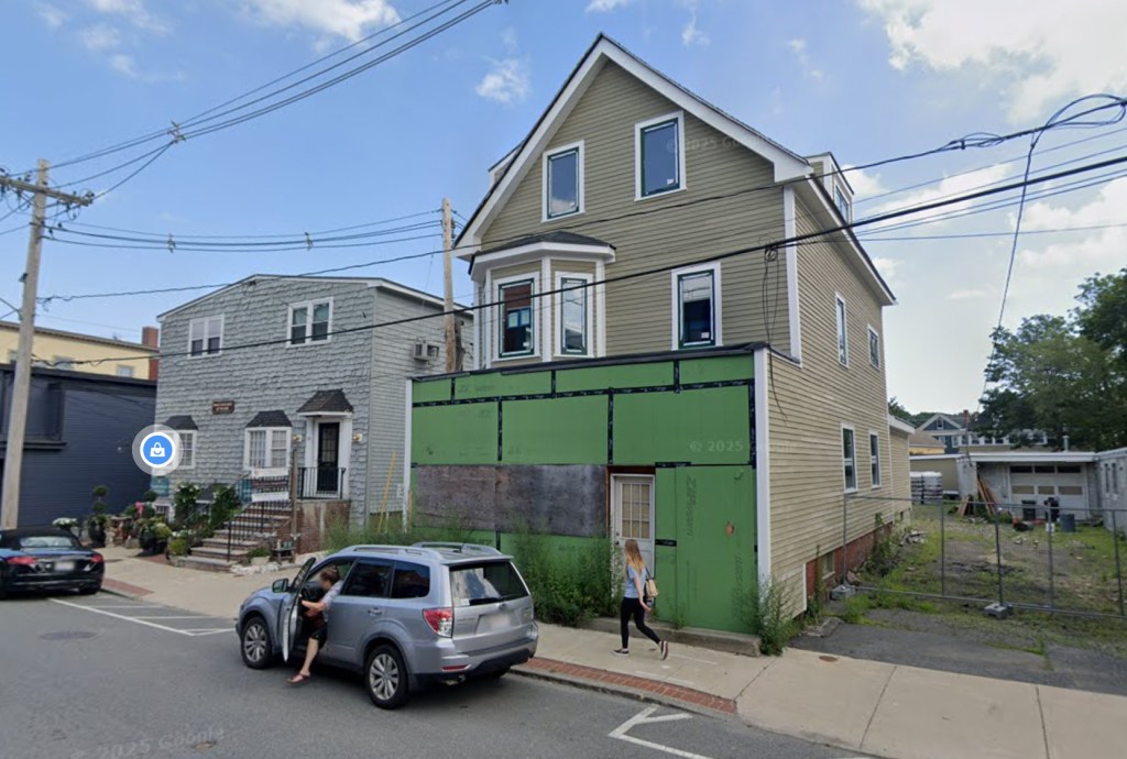 A view of the boarded up property at 120 Pleasant St.