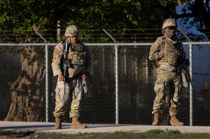 Members of the Texas National Guard stand guard at an army reserve training facility on October 07, 2025 in Elwood, Illinois. T