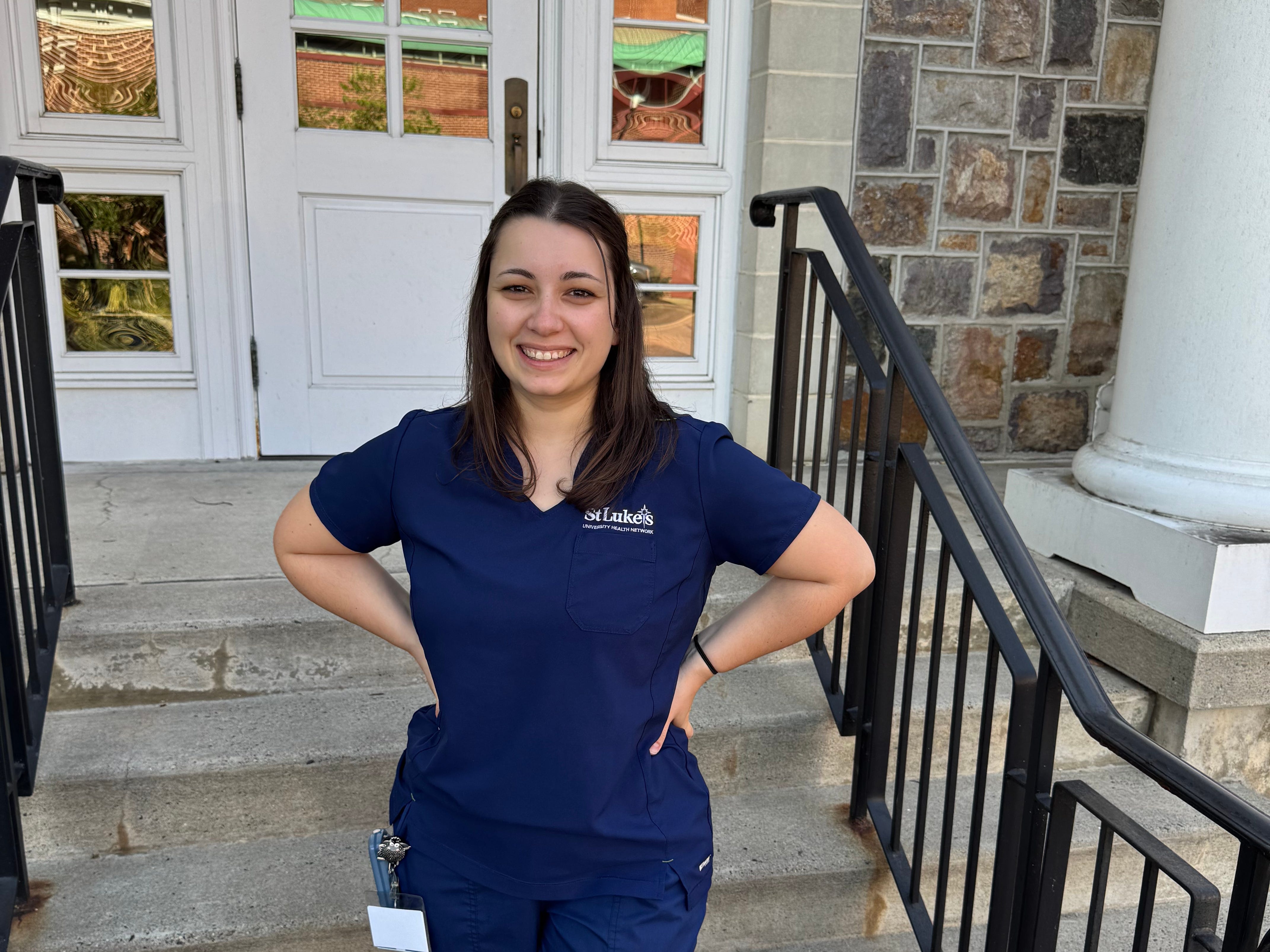 Nurse standing outside building