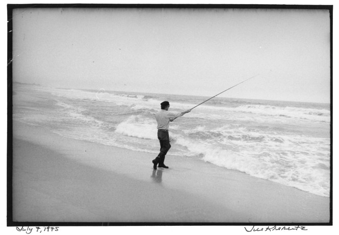 A black and white photo of Matthiessen fishing in the ocean 