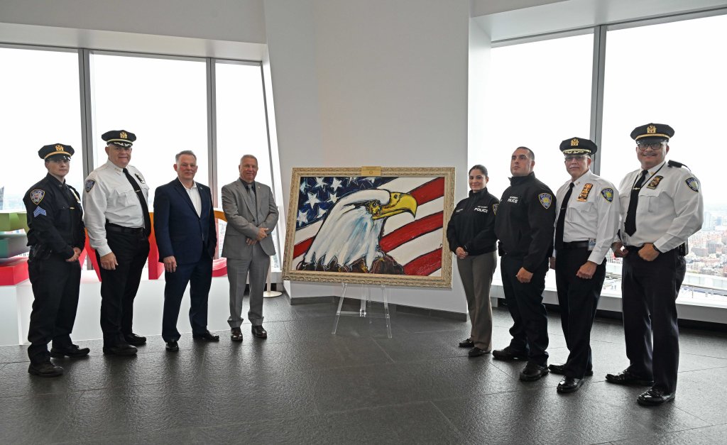 Members of Port Authority police and artist David Banegas pose with the new piece of art. 