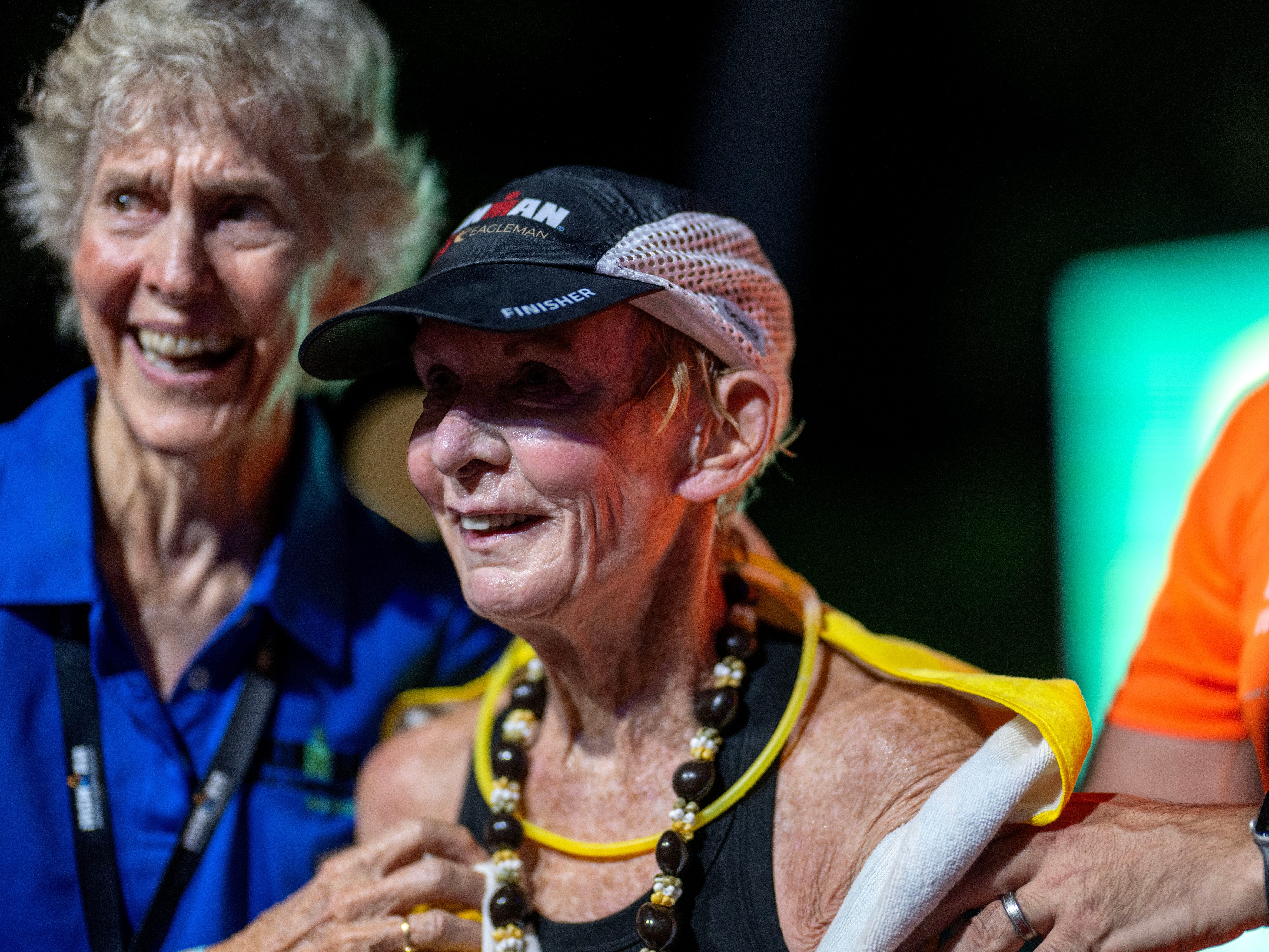 A senior woman is being congratulated after setting a world record in athletics