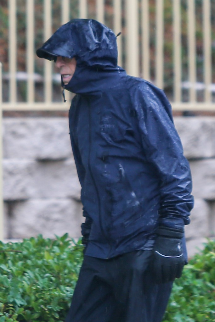 G. Scott Romney walking in the rain near his Valencia home.
