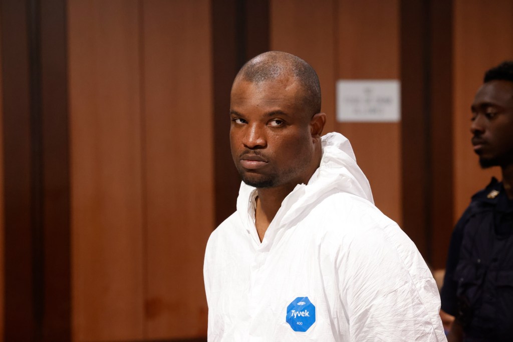 Jamel McGriff in a white Tyvek suit, accused of murder, arson, and robbery, during his arraignment.