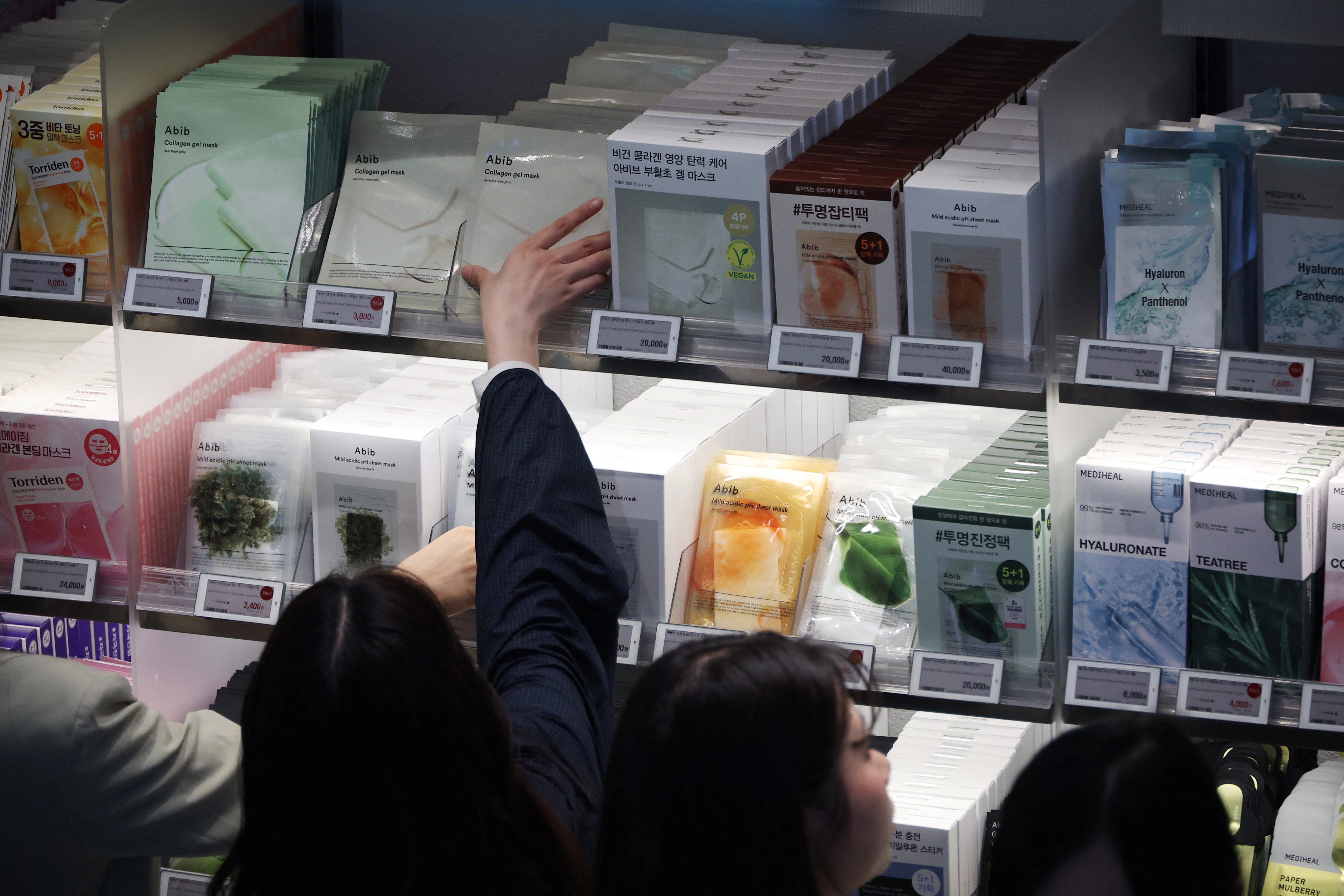 People shop at an Olive Young store in Seoul, South Korea, April 28, 2025.