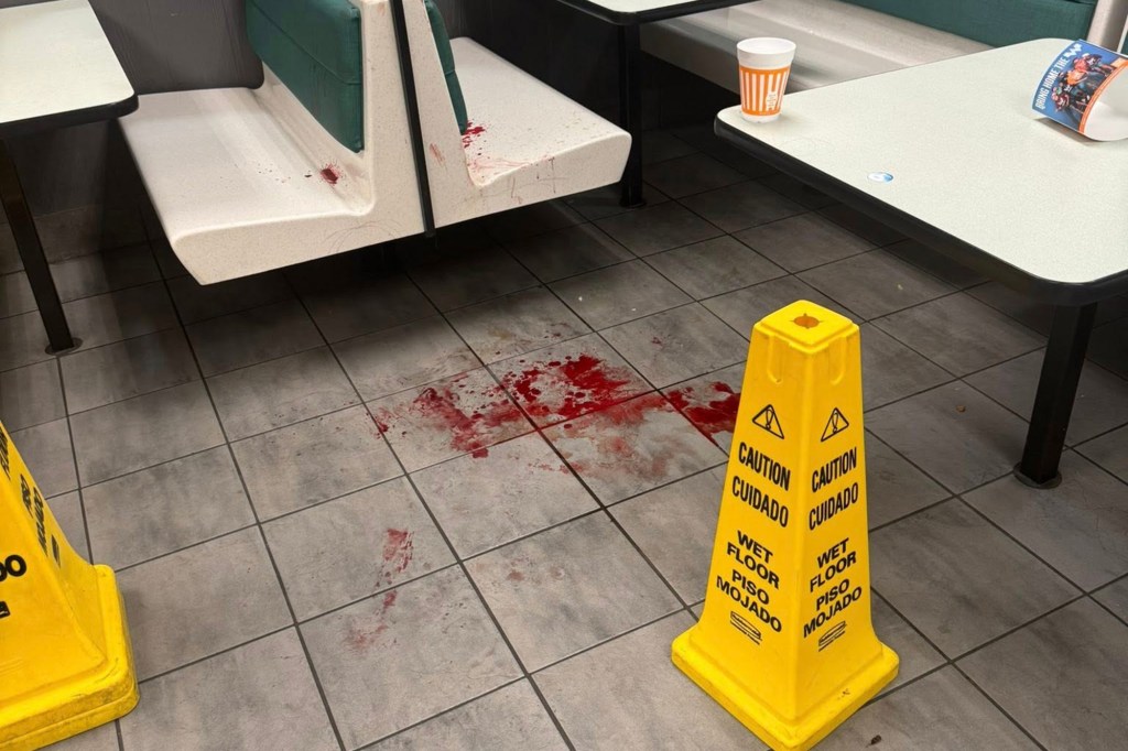 Blood splattered on a bench and floor at a Whataburger restaurant.