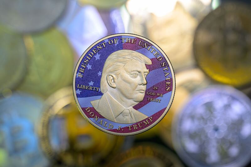 This photo illustration shows a representation of cryptocracy coins with the $Trump meme coin (collection coin) in Brussels, Belgium, on March 3, 2025.