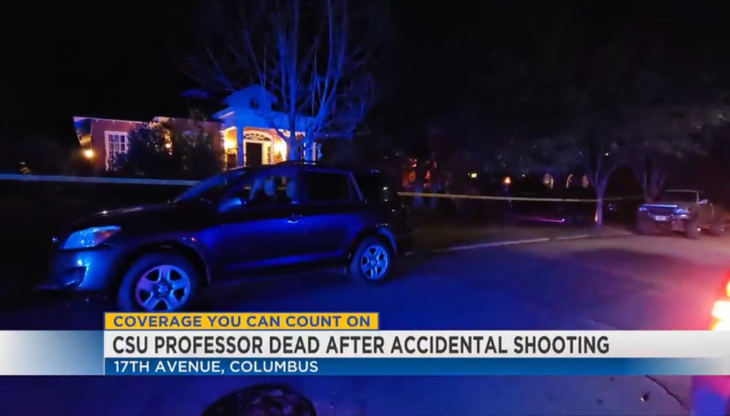 A news report showing a street at night with a blue-lit car in the foreground and a house in the background, with a yellow tape cordoning off the area.