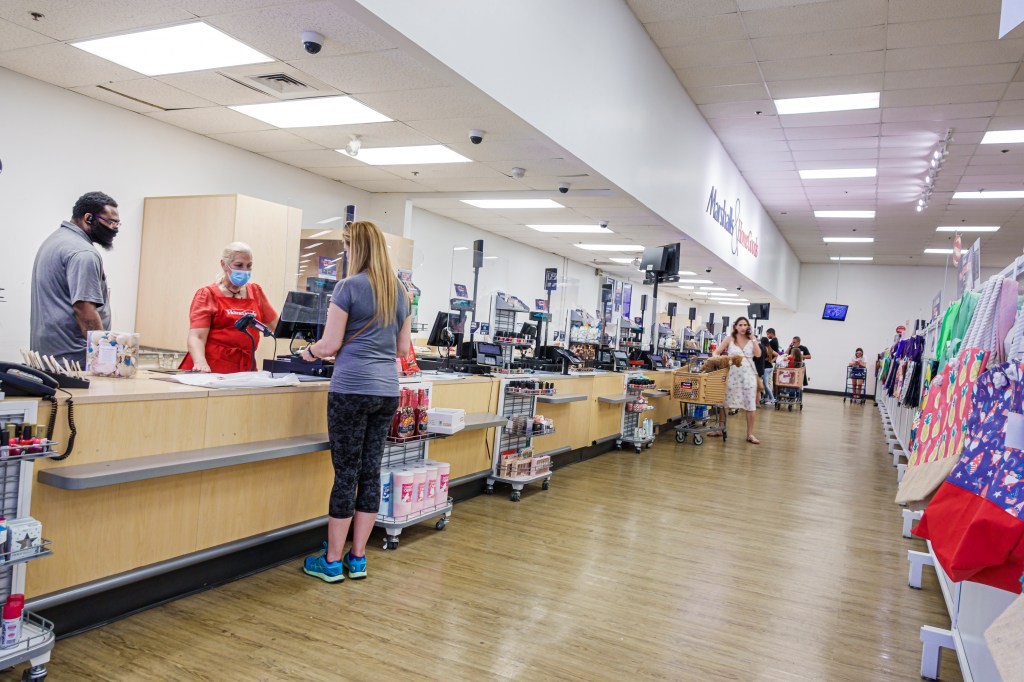 Two customers checking out at a Marshalls & HomeGoods store.