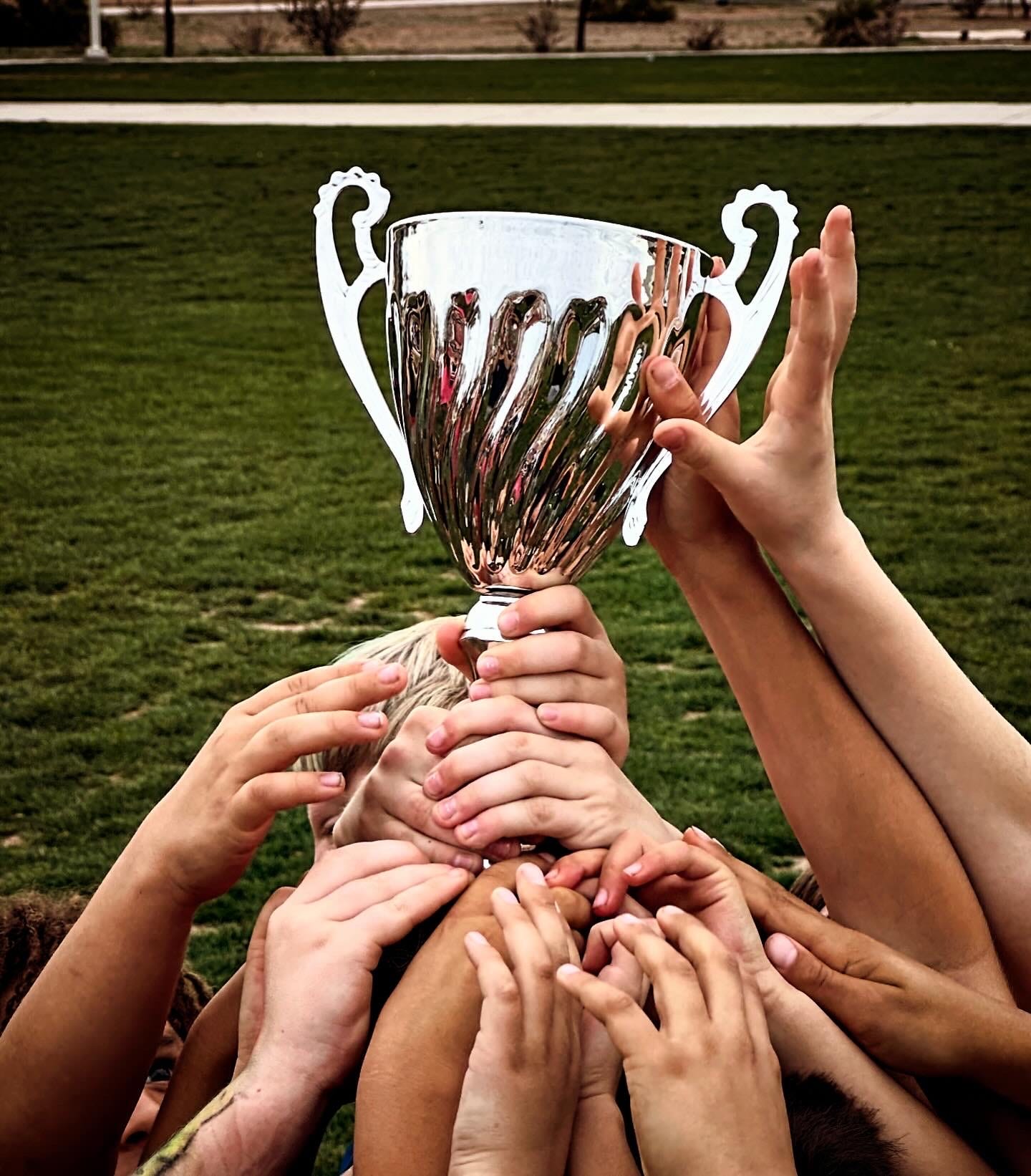 The author' son and his soccer team with a trophy.