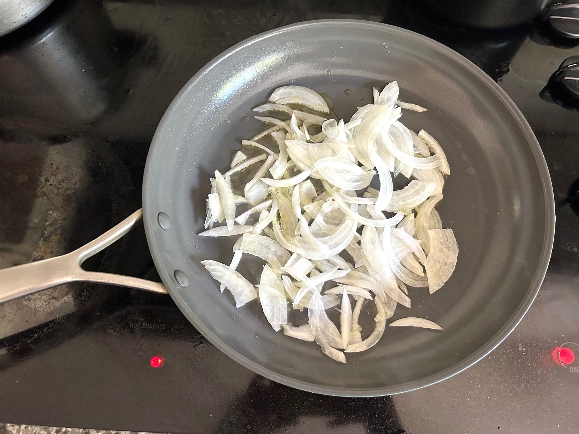 Cooking onions for Ina Garten's Eggs in Purgatory