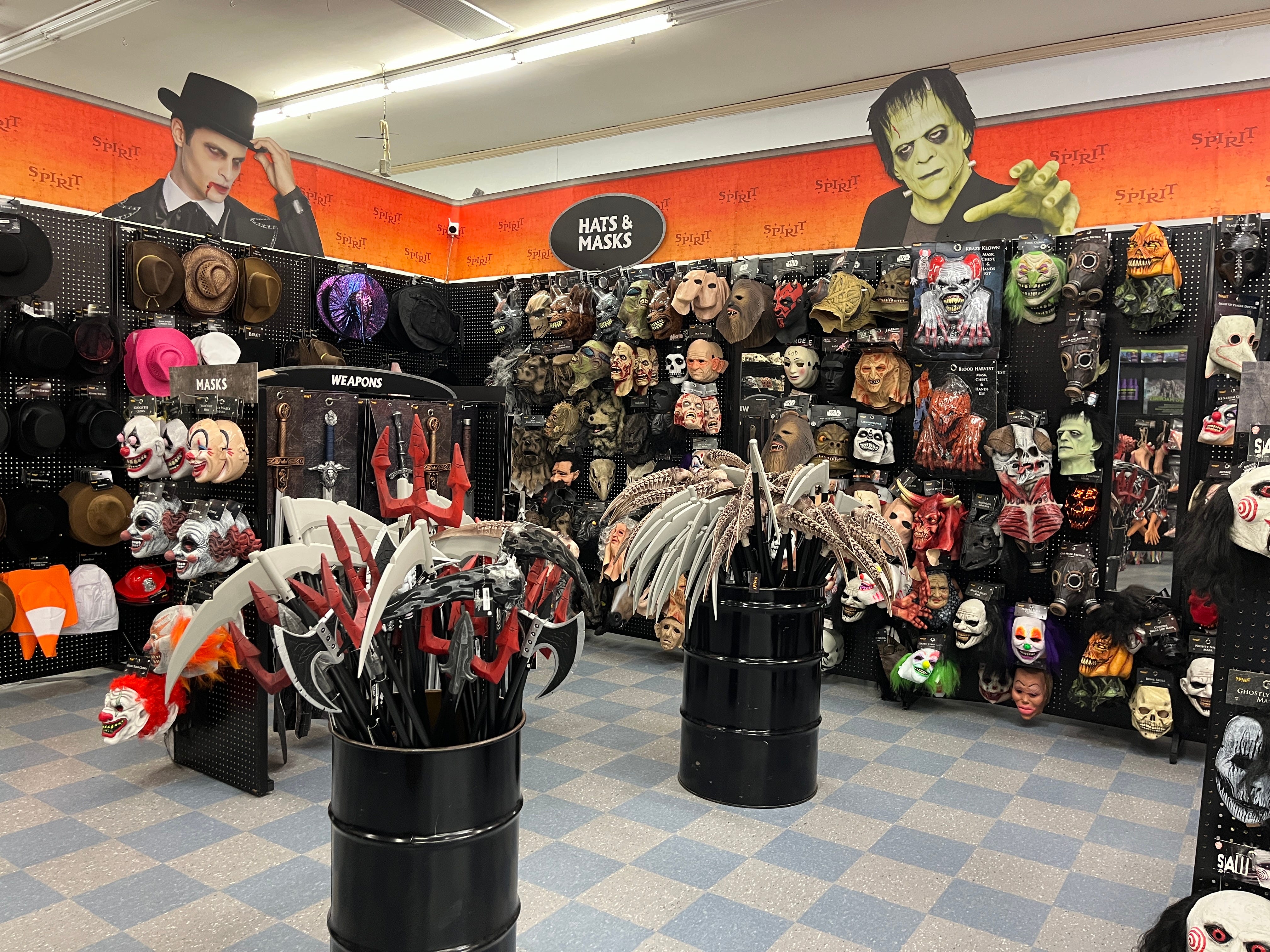 A display of Halloween accessories, hats, masks, and weapons at Spirit Halloween.