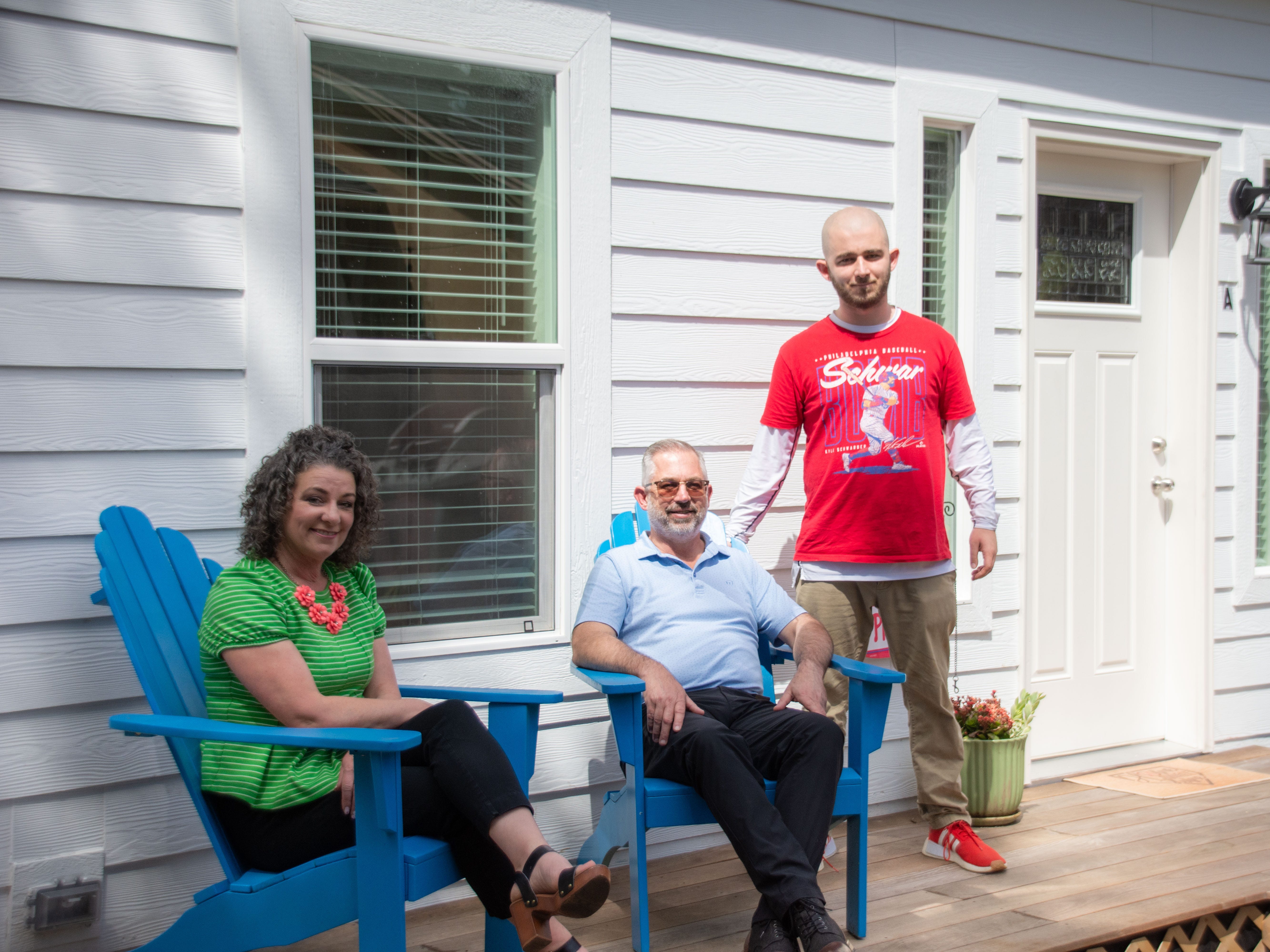 Todd Kutchta (center) and his wife and son are standing outside their ADU.
