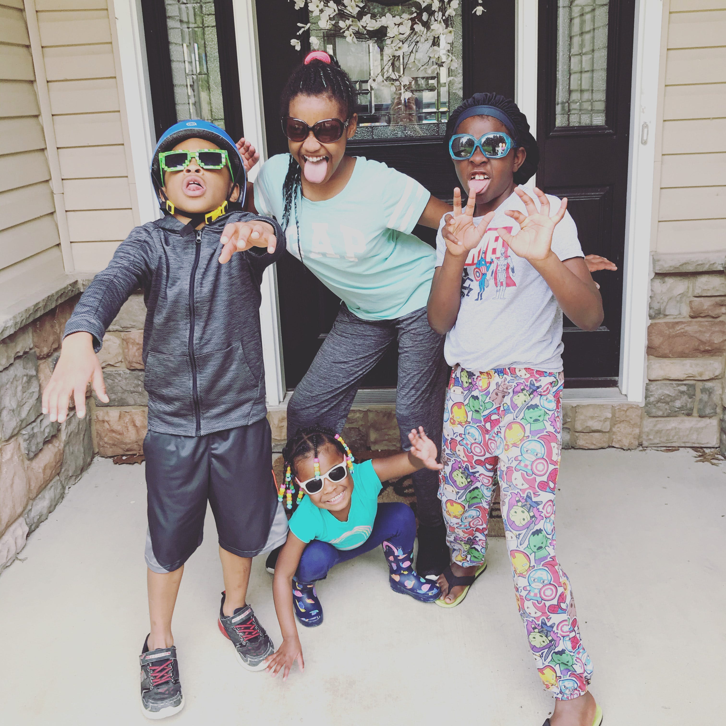 The author's children strike a funny pose in front of a door.