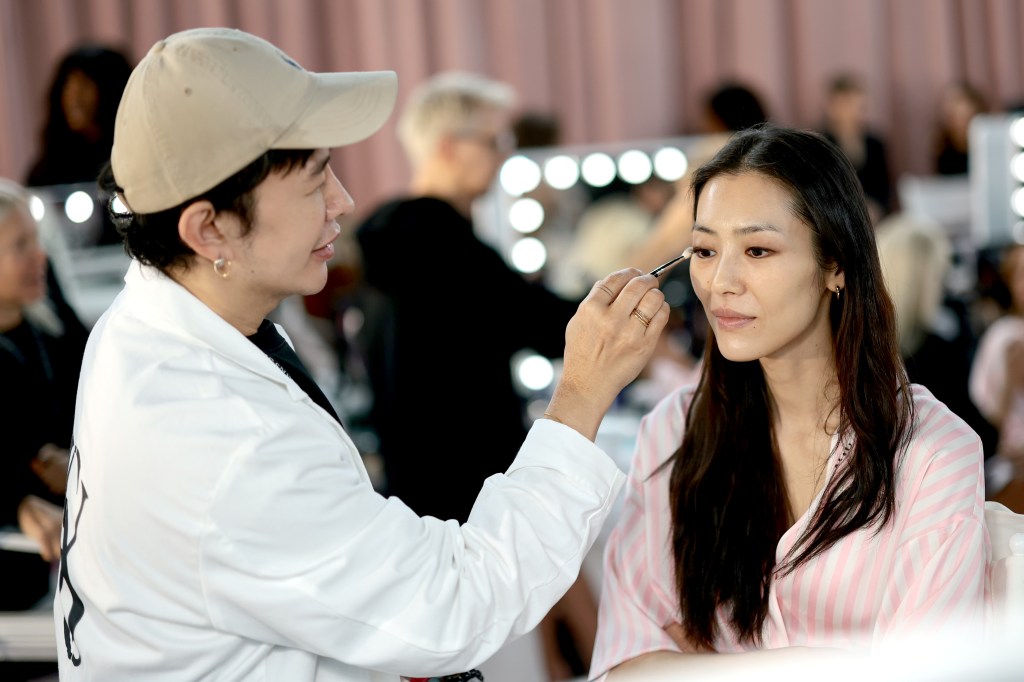 Liu Wen gets glammed up backstage before the Victoria's Secret Fashion Show