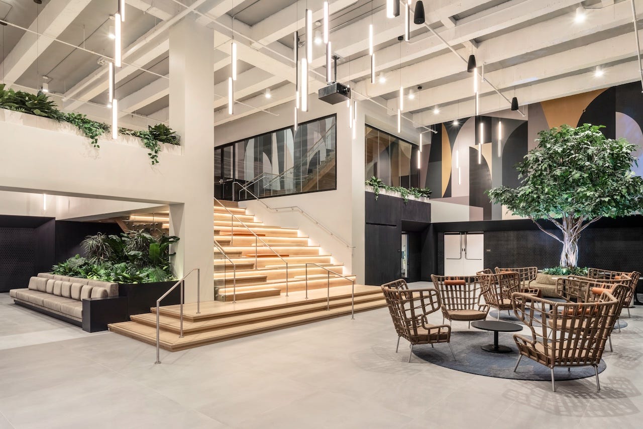 A stairway that leads to underground activity rooms, including a children's playroom, recording studios, and a lounge and karaoke area.