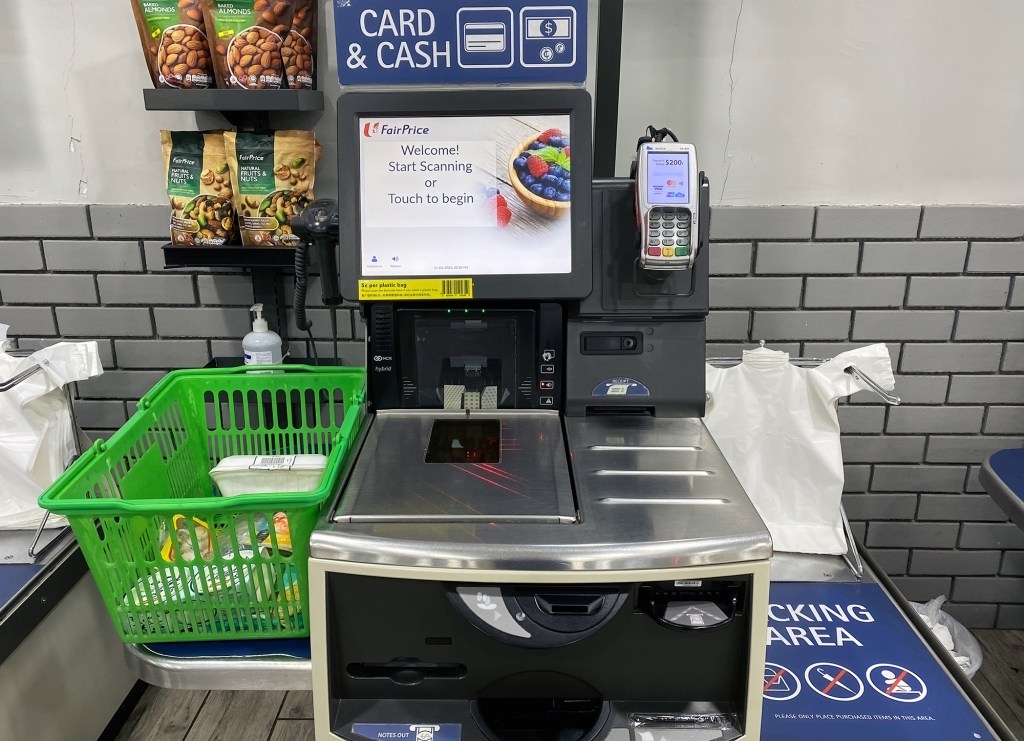 A self-checkout payment station at an NTUC FairPrice supermarket in Singapore, where plastic bags are charged a minimum of 5 cents.