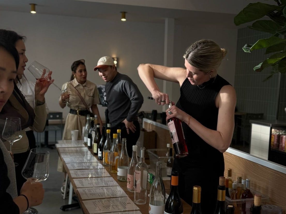 Camden Hauge is opening a bottle at the China Wine Club launch event in New York.