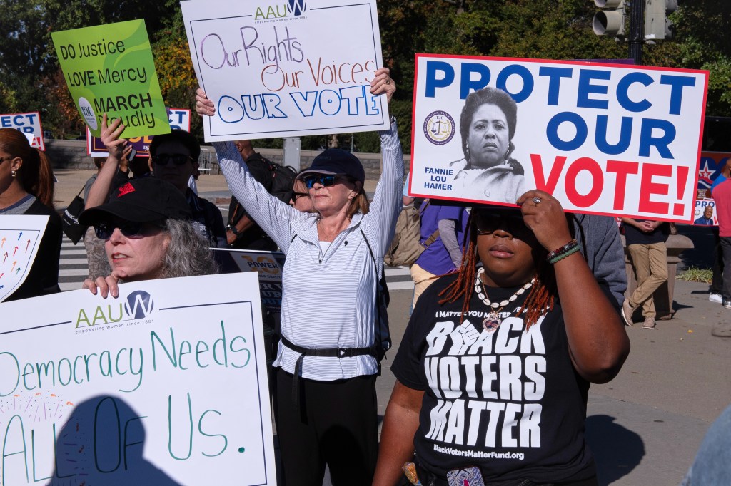 Voting rights activists protest outside the Supreme Court.