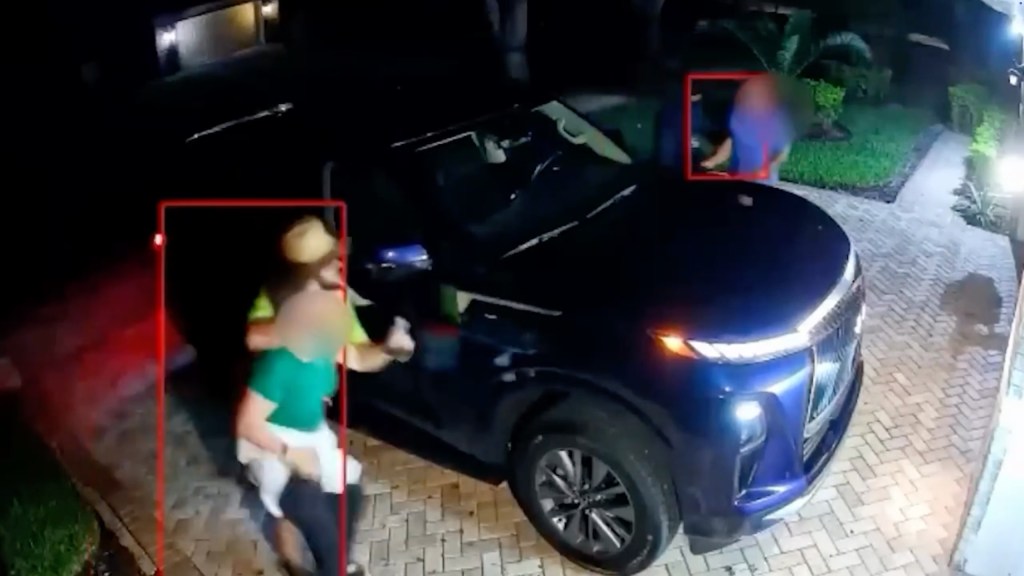 Two residents are grabbed at gunpoint by two armed men outside their home in Odessa, Florida, on Aug. 19, 2025.