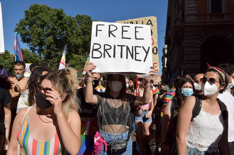ROME, ITALY - JUNE 26: People with a sign saying Free Britney, referring to Britney Spears take part in Rome Pride, the LGBTQIA+ parade, on June 26, 2021 in Rome, Italy. The Italian prime minister defended parliament after the Vatican requested a revision on an anti-discrimination draft bill that provides protection for LGBTQ persons, saying the new law could interfere with religious freedoms.
