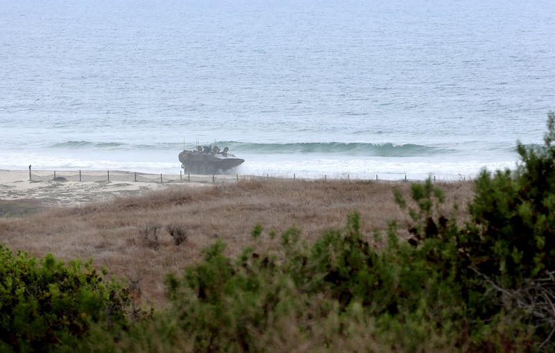 view from the Southbound I-5 Aliso Creek Rest Area of U.S. Marines driving through the surf as they train on Amphibious Combat Vehicles (ACV) at Camp Pendleton Friday, Sept. 26, 2025. Camp Pendleton has long remained the largest undeveloped stretch of the coastline in California. In the sweeping Southern California metropolis spanning from Santa Barbara to the Mexico border Camp Pendleton has long remained the largest undeveloped stretch of the coastline. The 17-mile stretch of beach has, since World War II, proven critical in preparing soldiers for amphibious missions. The bluffs, canyons and mountainous terrain that comprise the interior of the base has been fertile training ground for those sent to conflicts in the Middle East and beyond. But change may be on the horizon. The United States Department of Defense is considering making a portion of the 125,000 acre base in northwestern San Diego County available for development or lease in what, if successful, would be unprecedented for the military installation.